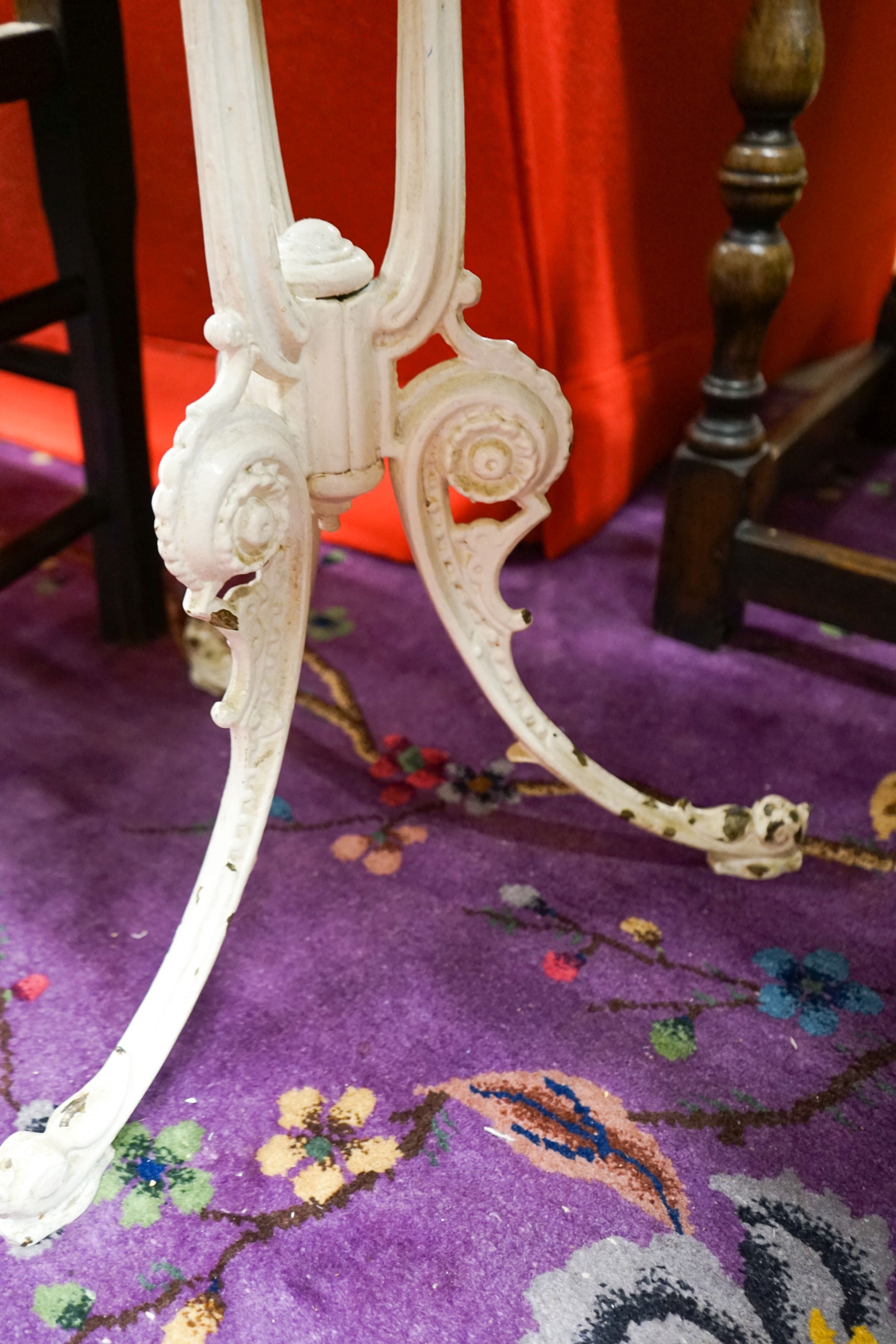 A near pair of painted cast iron circular marble top tables, larger 60cm diameter, height 71cm